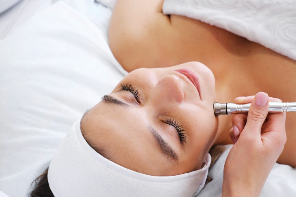 A woman relaxes while receiving a 3D Skin Rejuvenation Treatment for smoother skin.