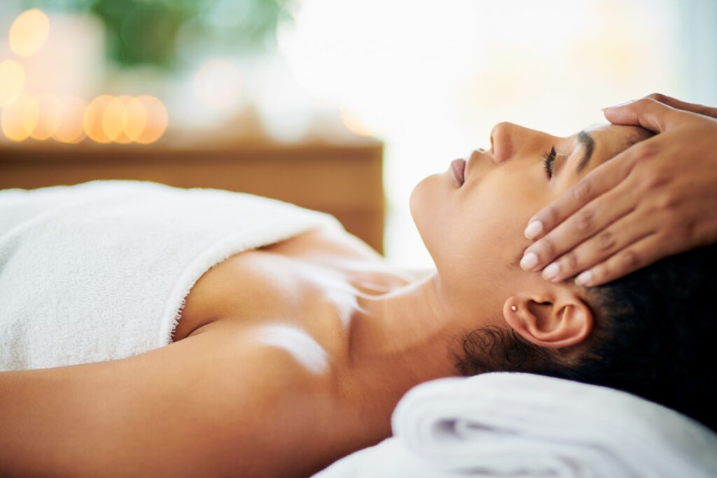 A peaceful Aromatic Facial therapy session with a client lying on a spa bed in a calm setting.