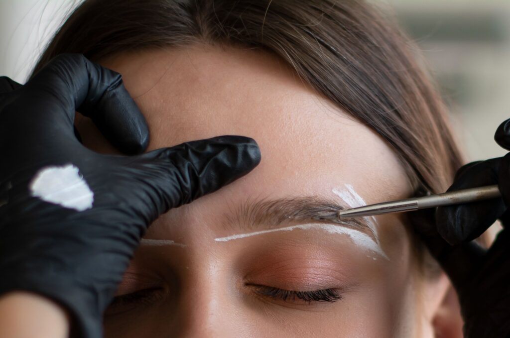 Brow shaping and styling during a Brow Lamination procedure with precise tools.