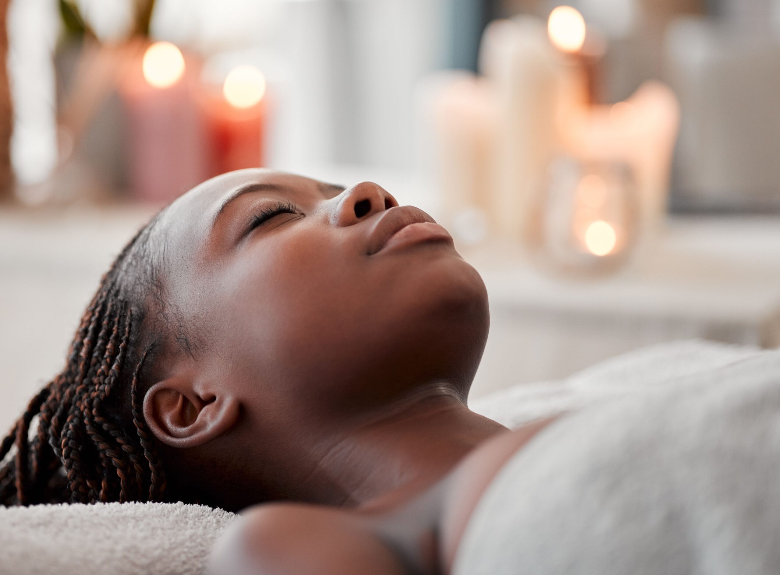 A woman receiving a relaxing aromatic facial in a serene spa environment, perfect for rejuvenating skin.