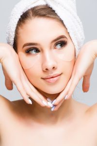 beautiful young woman face with white towel her head