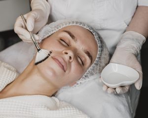 young woman getting face skin treatment